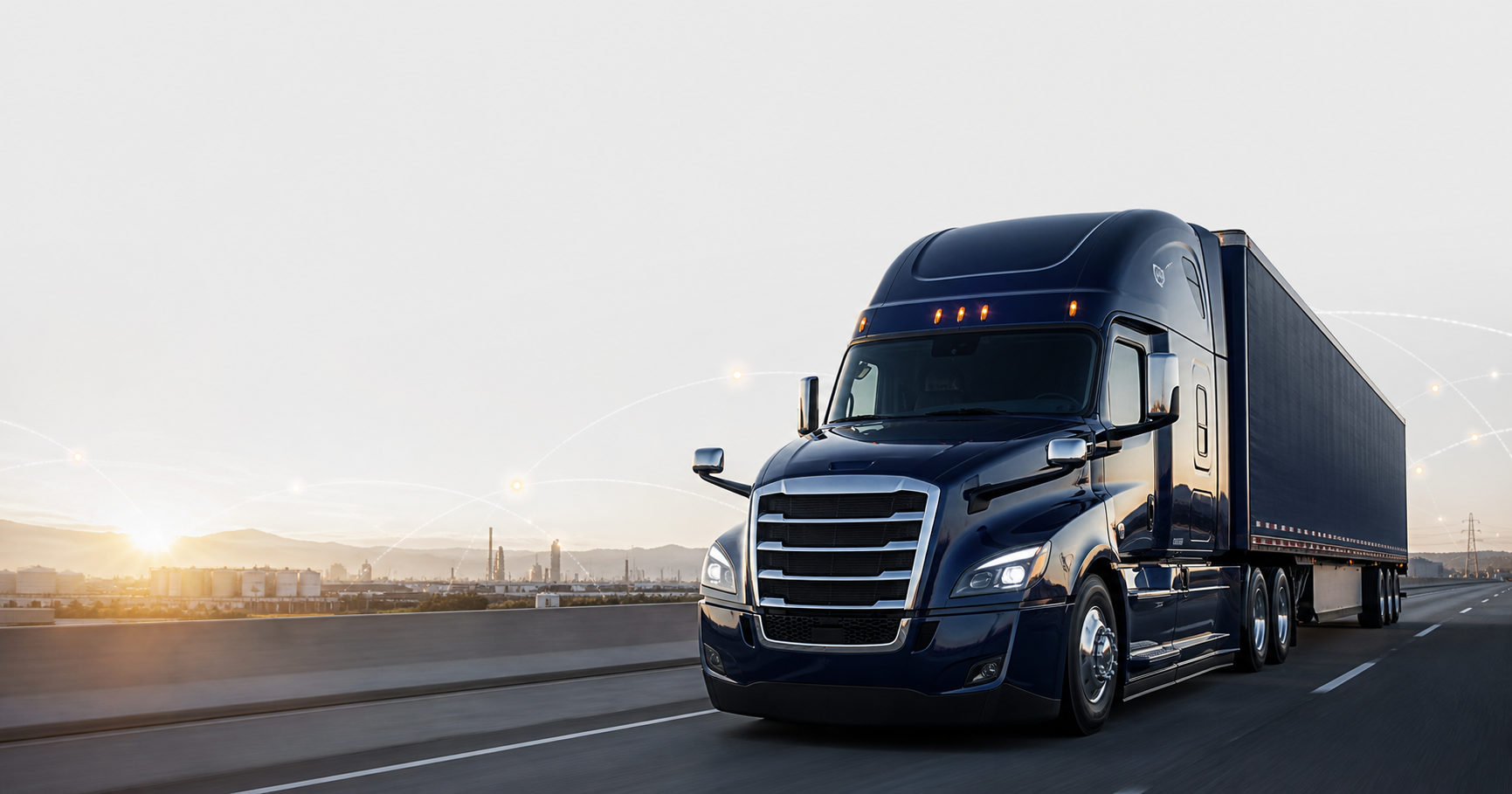 Dark blue semi truck and trailer driving on an American interstate